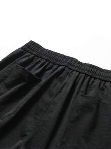 Pantalones cargo holgados de hombre unicolor con múltiples bolsillos, pantalones deportivos con cordón para uso en exteriores