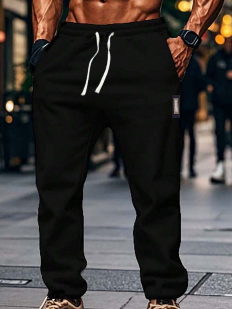 Calças masculinas clássicas cortadas, calças jogger de malha de poliéster com cós elástico e cordão, vários bolsos, calças esportivas casuais adequadas para corrida, caminhada e atividades ao ar livre - cor sólida, ajuste solto, todas as estações - Preto - Ver 1