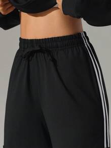 Pantalones deportivos casuales de tiro alto con bolsillos y raya lateral, de corte holgado. Pantalones de yoga con cordón, cintura elástica y puños, apropiados para el uso diario, trotar, hacer ejercicio
