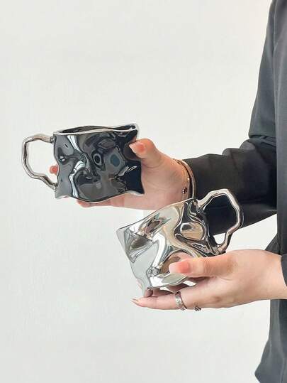 This Is An Asymmetrical-Shaped Mug With A Distinctive Asymmetrical Shape And A Smooth Metallic Texture. Its Design Breaks Away From The Traditional Mug Form, Presenting A Modern And Artistic Style That Makes It An Excellent Home Decor Or Collectible Item. Back To School
