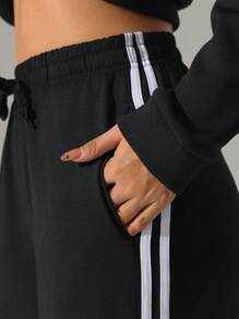 Pantalones deportivos casuales de tiro alto con bolsillos y raya lateral, de corte holgado. Pantalones de yoga con cordón, cintura elástica y puños, apropiados para el uso diario, trotar, hacer ejercicio