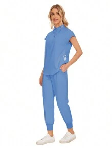 Conjunto uniforme hospitalario y dental de moda al por mayor con bata quirúrgica de unicolor, bolsillo, cuello en V, conjunto de uniformes de pantalones tipo jogger para mujeres
