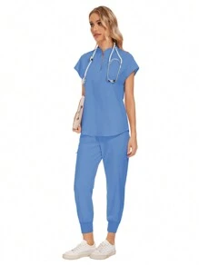 Conjunto uniforme hospitalario y dental de moda al por mayor con bata quirúrgica de unicolor, bolsillo, cuello en V, conjunto de uniformes de pantalones tipo jogger para mujeres