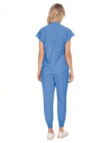 Conjunto uniforme hospitalario y dental de moda al por mayor con bata quirúrgica de unicolor, bolsillo, cuello en V, conjunto de uniformes de pantalones tipo jogger para mujeres