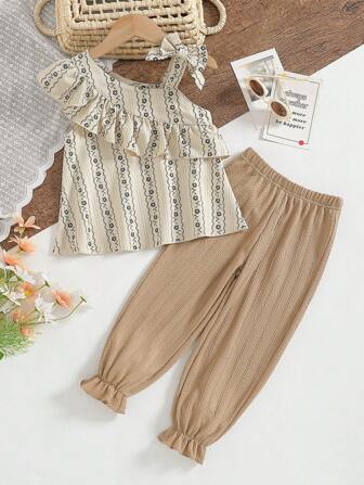 年轻女孩露肩上衣和裤子两件套，时尚春夏