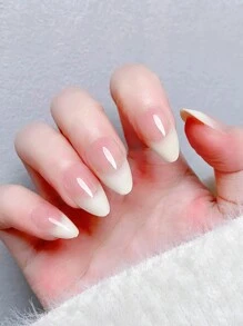 24 pièces d'ongles artificiels en forme d'amande avec une manucure française dégradée nude et blanc laiteux. Comprend 1 lime à ongles et 1 gel de gelée