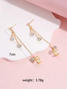 1 paire de boucles d'oreilles dorées style hip hop avec chaîne de strass à gland clip sur l'oreille