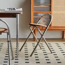 Une chaise de dossier pliable en acier inoxydable et rotin, simple et de luxe léger pour petit appartement. Tabouret de salle à manger pratique