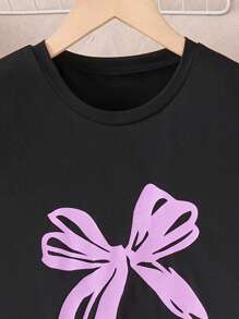 A 2 Pieces Set Of Fashionable Tween Girl Home Clothes, A Casual Purple Bow Printed Round Neck Black Short Sleeved Top Paired With A Black Full Printed Colorful Bow Pattern Straight Leg Pants Set, Suitable For Casual Wear At Home In Spring, Autumn, And Summer