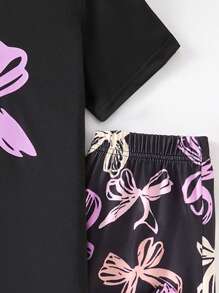 A 2 Pieces Set Of Fashionable Tween Girl Home Clothes, A Casual Purple Bow Printed Round Neck Black Short Sleeved Top Paired With A Black Full Printed Colorful Bow Pattern Straight Leg Pants Set, Suitable For Casual Wear At Home In Spring, Autumn, And Summer