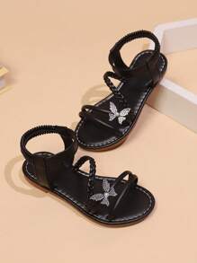 زوج من الصنادل المسطحة للبنات 'صغيرات الحجم، من الجلد الصناعي، مزينة بسيور مزدوجة على الكتف بالراينستون واللؤلؤ والفراشات، تصميم إغلاق مرن للكاحل ، إصبع القدم مفتوح وقاعدة مضادة للانزلاق، موضة أسود جميلة مناسبة لفتيات عمر 3-15 سنة، لليومي أو العطل الصيفية