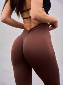 Bezszwowe legginsy do jogi z wysokim stanem i wycięciem na plecach w serek i podnoszące pośladki