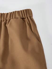 Pantalon décontracté à la mode, lâche et simple, de couleur marron, à jambe droite, convenant aux préadolescentes. Conception à plusieurs poches. Convient pour le printemps et l'automne. Vêtements quotidiens, de plein air, de fête et de campus