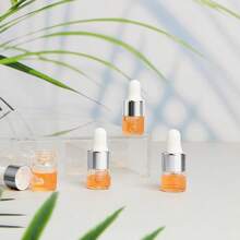 100 Pcs Mini Glass Dropper Bottle Bulk Clear Essential Oil Dropper Bottles Small Glass Dropping Sample Containers Perfume Liquid Cosmetic Sample Vials With Cap For Traveling (Silver,1 Ml)