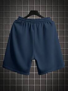 Pantalones cortos deportivos informales sueltos con cordón a la cintura, bolsillos laterales y estampado de letras de unicolor para hombres