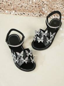 Sandały 2025 Lato Nowe Modne All-In-One Okrągły Nosek Płaskie Antypoślizgowe Motyl Kryształki Plaża Do Noszenia Wsuwane Dziecięce Buty Dziewczęce