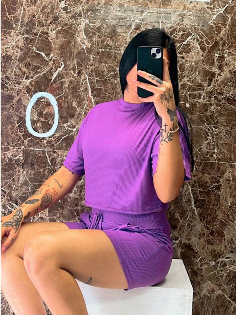 Este conjunto de dama es perfecto para los días cálidos, compuesto por una blusa de manga corta y un short corto, ideales para un look fresco y cómodo. La blusa presenta un diseño sencillo con cuello redondo, proporcionando un toque clásico y elegte, mientras que el short corto liso, confeccionado en tela CANALE, ofrece una textura resistente y cómoda. La tela CANALE, conocida por su durabilidad y suavidad, asegura un ajuste cómodo durante todo el d, mientras que su diseño liso lo hace fácil de combinar con accesorios y calzado, adaptándose a diferentes estilos. Es un conjunto versátil, perfecto para paseos, reuniones informales o para disfrutar del verano con estilo. - Morado - Ver 1