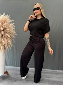 Set 2 piezas acanalado de blusa holgada con cordón en frente hombros caídos y pantalón acampanado con bolsas laterales y cordón en pretina de cintura tela fresca