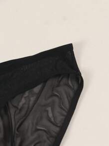 Herren schwarze sexy Mesh-Unterwäsche, halbtransparent mit süßem Herz-Augen-Druckmuster, atmungsaktiv und bequem als Alltagsunterwäsche Tangas