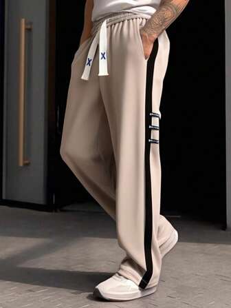 男士运动长裤，采用轻松时尚的休闲风格和拼接设计，适合徒步旅行、跑步、运动、旅行和休闲活动。