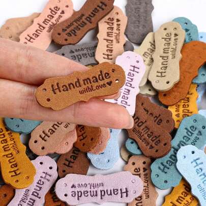 15/25/50pcs Handmade Leather Labels, Microfiber Colorful Leather Labels With Heart Handmade Embossed Crochet Tags With Holes For Crafts Knitting Sewing Hats Purses Clothing (10 Colors)-Random Color