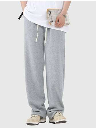 Pantalones de chándal casuales grises de pierna ancha con cordón para hombres, pantalones versátiles y suaves para jóvenes, ideales para el ocio y los trayectos, primavera