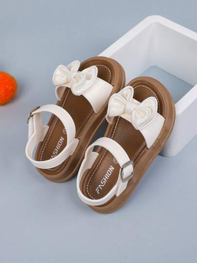 1 双纯色女童平底凉鞋，带蝴蝶结和钩环设计，适合夏季
