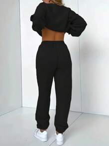 A Two Piece Set Consisting Of A Solid Color Long Sleeve Kangaroo Sweatshirt And Tracksuit Jogger Sweatpants - Black - View 2