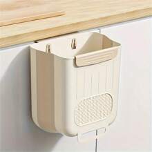 Un organizador de basura de cocina plegable de plástico que se puede colgar en las puertas de los armarios y un contenedor de almacenamiento de clasificación de basura montado en la pared