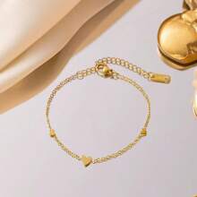 Conjunto de joyería de collar y pulsera con forma de corazón romántica, de acero de titanio en tono dorado, diseño único para mujer
