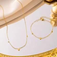 Conjunto de joyería de collar y pulsera con forma de corazón romántica, de acero de titanio en tono dorado, diseño único para mujer