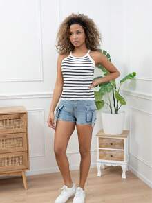 Orange ribbed sleeveless top with black stripes and scalloped edges. This sleeveless top features striking black stripes on a vibrant orange background, high ing maximum comfort. The round neckline and slim straps add a casual, summery vibe, perfect for relaxed outfits or sunny outings. Pair it with denim shorts or a skirt for a fresh and dynamic look.