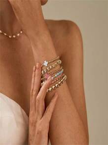Set de 6 pulseras apilables con perlas falsas de estilo dorado
