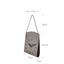 Une horloge de sac suspendu au design créatif d'art moderne. Décoration vintage personnalisée pour le salon. Horloge décorative silencieuse pour la maison et la chambre à coucher. Pendentif d'horloge de style moderne et luxueux, très attrayant. Horloge murale en forme de sac pour restaurant et café
