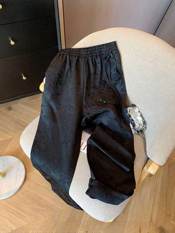 Pantalon ample évasé à taille élastique en satin jacquard noir avec effet affinant pour femmes