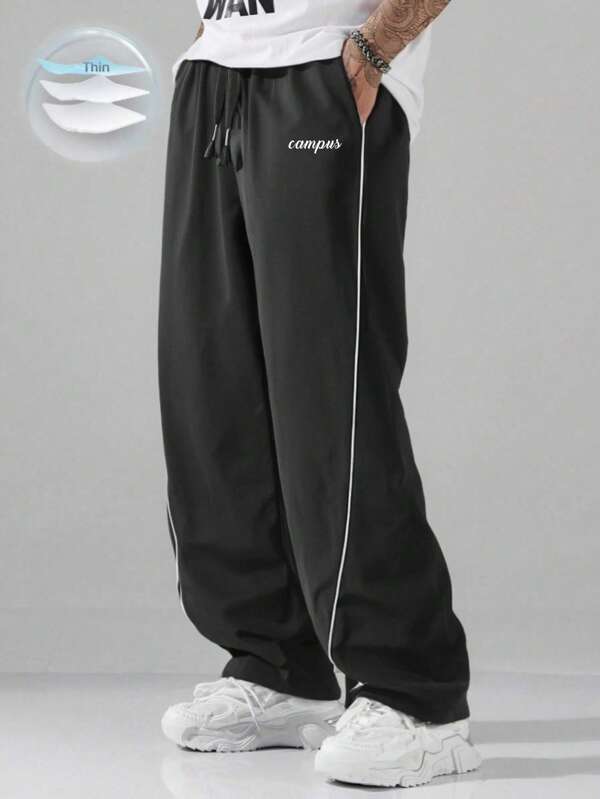 Men's Lightweight Contrast Trim Pants, Loose Long Parachute Trousers With Letter Graphic Design, Solid Black, Casual Wear