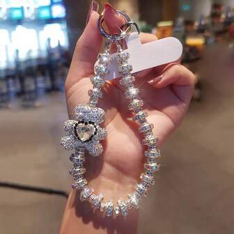 1 pieza Brazalete rígido con cristal con diseño de oso totalmente cubierto de strass, accesorio de lujo de moda para la muñeca, con cojín blanco, regalo para madre, familia, amigos, cumpleaños, días festivos, decoración de celular, cadena de celular