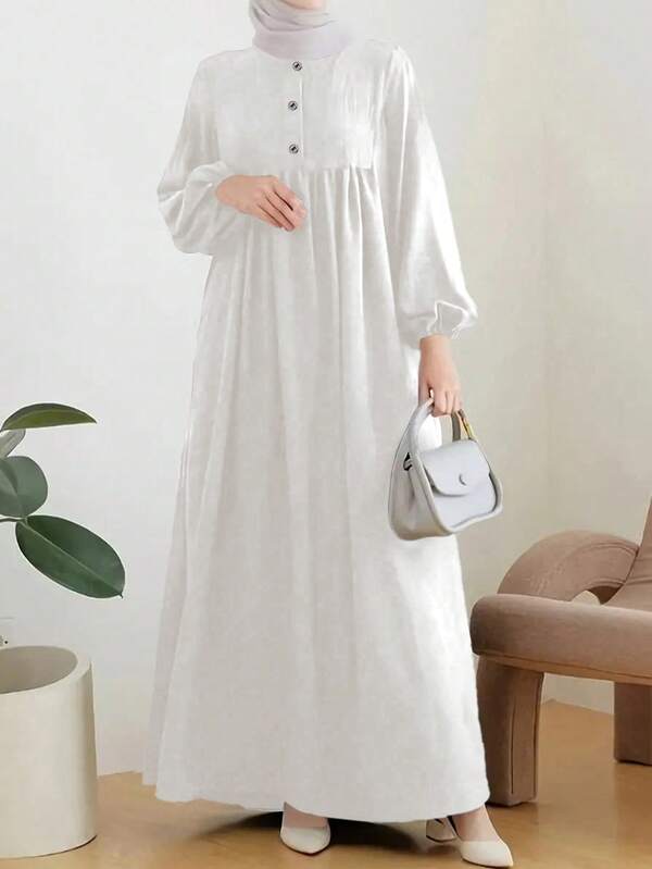 Gonna lunga a tinta unita con bottoni, manica a lanterna elegante, ampia e semplice, sobria