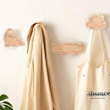 Cartoon-Style Solid Wood Hooks That Can Have Names Customized On Them. They Are Extremely Convenient As They Are No-Drill And Can Be Mounted On The Wall. They Are Especially Suitable For Being Used As Door Handles For Children's Drawers And Cabinets, And They Are Truly A Must-Have For Organizing Clothes And Hats.