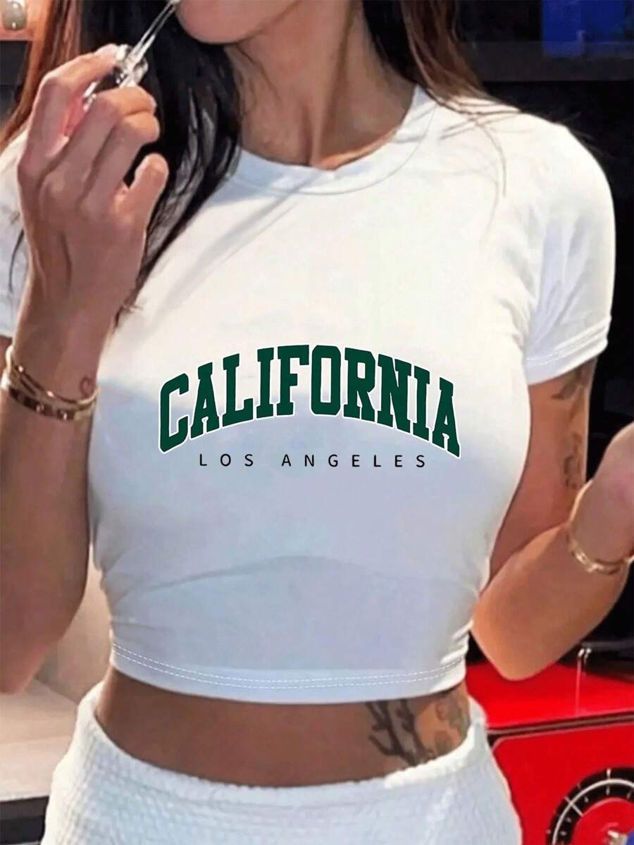100% Cotton Unisex Crop T-Shirt Showcasing California And Los AngelesA White Cropped Tee With The Word "CALIFORNIA" In Large Green Letters And "LOS ANGELES" In Smaller Black Letters Below. Round Neck Short - Sleeve T - Shirts, Basic Tees, And Graphic Crop Tops Are Summer Women's Tops. - White - View 1