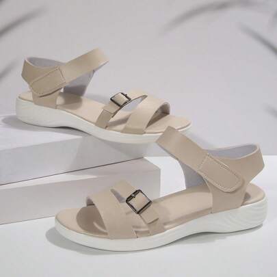 Giày sandal đế mềm tối giản cho nữ, giày sandal đế bằng phong cách La Mã thời trang mới cho học sinh, giày cỡ lớn màu trơn khóa cài, thiết kế bất đối xứng khoét rỗng, mặc hàng ngày