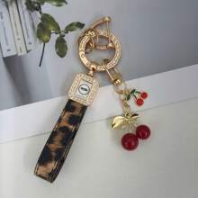 TTOBS 1pc Exquisitely Crafted Leopard Print Leather Car Key Chain With Adorable Cherry Pendant - , Fashionable And Multi-Functional Backpack Keychain - The Perfect Accessory For Backpacks. The Perfect Valentine's Day Gift, Also An Ideal Gift For Your Beloved Girlfriend.