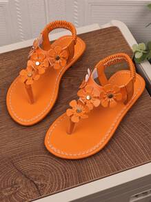 1 par de sandalias planas naranja para niñas de talla grande, con chanclas de piel de PU y hebilla de metal con rhinestones, 4 decoraciones de flores, espalda elástica, punta redonda y abierta, sandalias romanas adecuadas para niñas de 3 a 15 años para uso diario casual, fiesta, viaje, playa, primavera/verano 2025