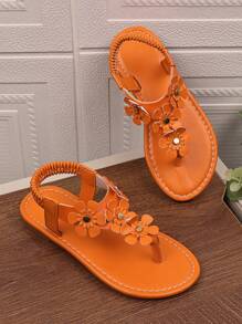 1 par de sandalias planas naranja para niñas de talla grande, con chanclas de piel de PU y hebilla de metal con rhinestones, 4 decoraciones de flores, espalda elástica, punta redonda y abierta, sandalias romanas adecuadas para niñas de 3 a 15 años para uso diario casual, fiesta, viaje, playa, primavera/verano 2025