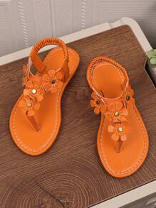 1 par de sandalias planas naranja para niñas de talla grande, con chanclas de piel de PU y hebilla de metal con rhinestones, 4 decoraciones de flores, espalda elástica, punta redonda y abierta, sandalias romanas adecuadas para niñas de 3 a 15 años para uso diario casual, fiesta, viaje, playa, primavera/verano 2025