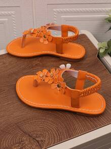 1 par de sandalias planas naranja para niñas de talla grande, con chanclas de piel de PU y hebilla de metal con rhinestones, 4 decoraciones de flores, espalda elástica, punta redonda y abierta, sandalias romanas adecuadas para niñas de 3 a 15 años para uso diario casual, fiesta, viaje, playa, primavera/verano 2025