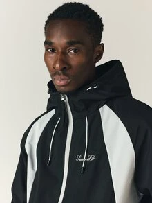 SUMWON Club Oversized Windbreaker Jacket With Hood Zip Closure Color Block White Panels And Logo Script Print - Black - View 6