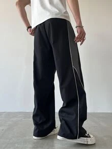 Manfinity EMRG 男士时尚宽松抽绳腰裤，侧边拼色设计。男士阔腿裤，男士直筒裤。适合日常穿着、外出、运动休闲、上学、派对、音乐节、休闲。可作为送给朋友、男朋友、秋季的礼物。 - 黑色 - 查看 2