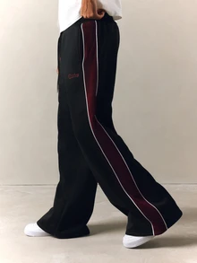 PLAYBOY X SUMWON Wide Leg Track Pants With Burgundy Side Panel Contrast Piping Embroidered Script Logo Drawstring Waist Full Length - Black - View 1