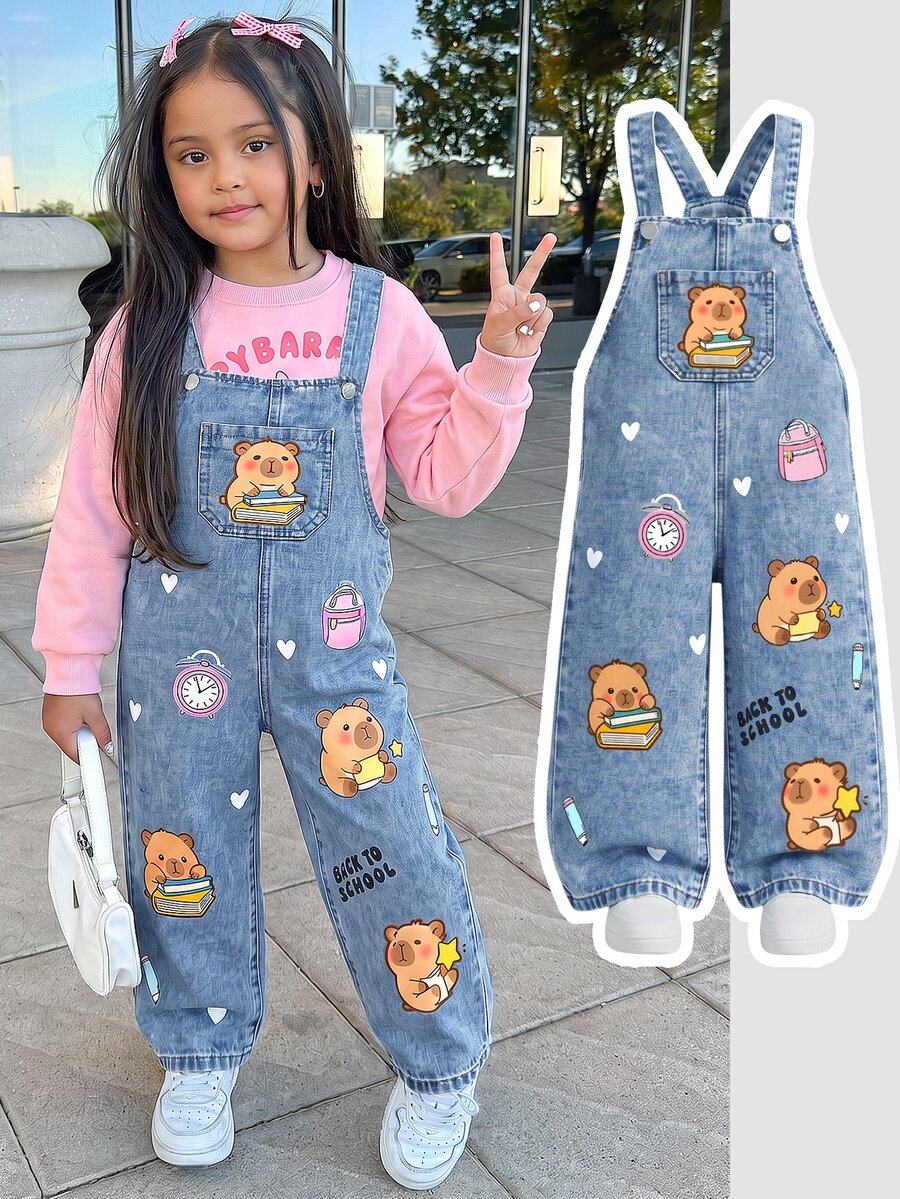 SHEIN Young Girls' Denim Overalls Long Pants, All-Season, Soft, Cotton, Casual, Fashionable, Versatile, Comfortable, Minimalist, Cute, Adjustable Shoulder Strap Button Design, Front Card-Style Cartoon Print, Loose Fit, Medium Blue Washed Denim Overalls Long Pants Suitable For Daily Wear And Vacation